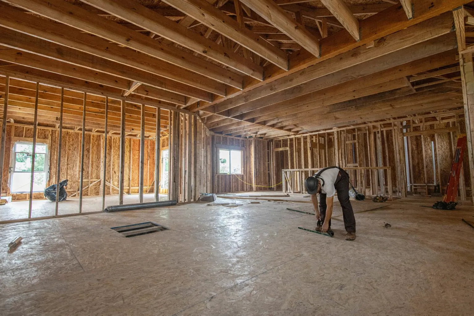 Interior wood-stud framing inside a home addition under construction