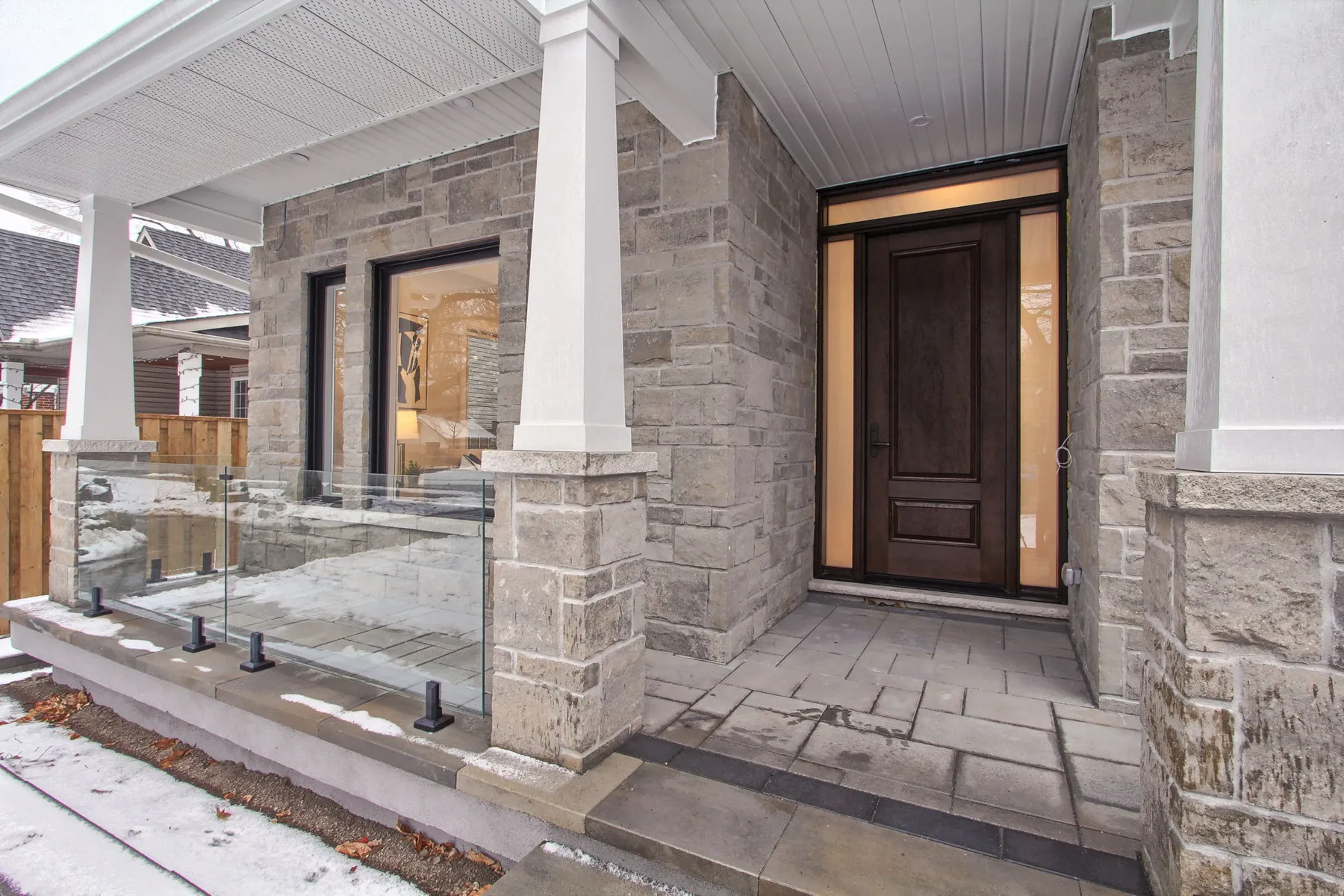 The stone entry porch of a completed custom home, the point a construction mortgage converts to a standard one