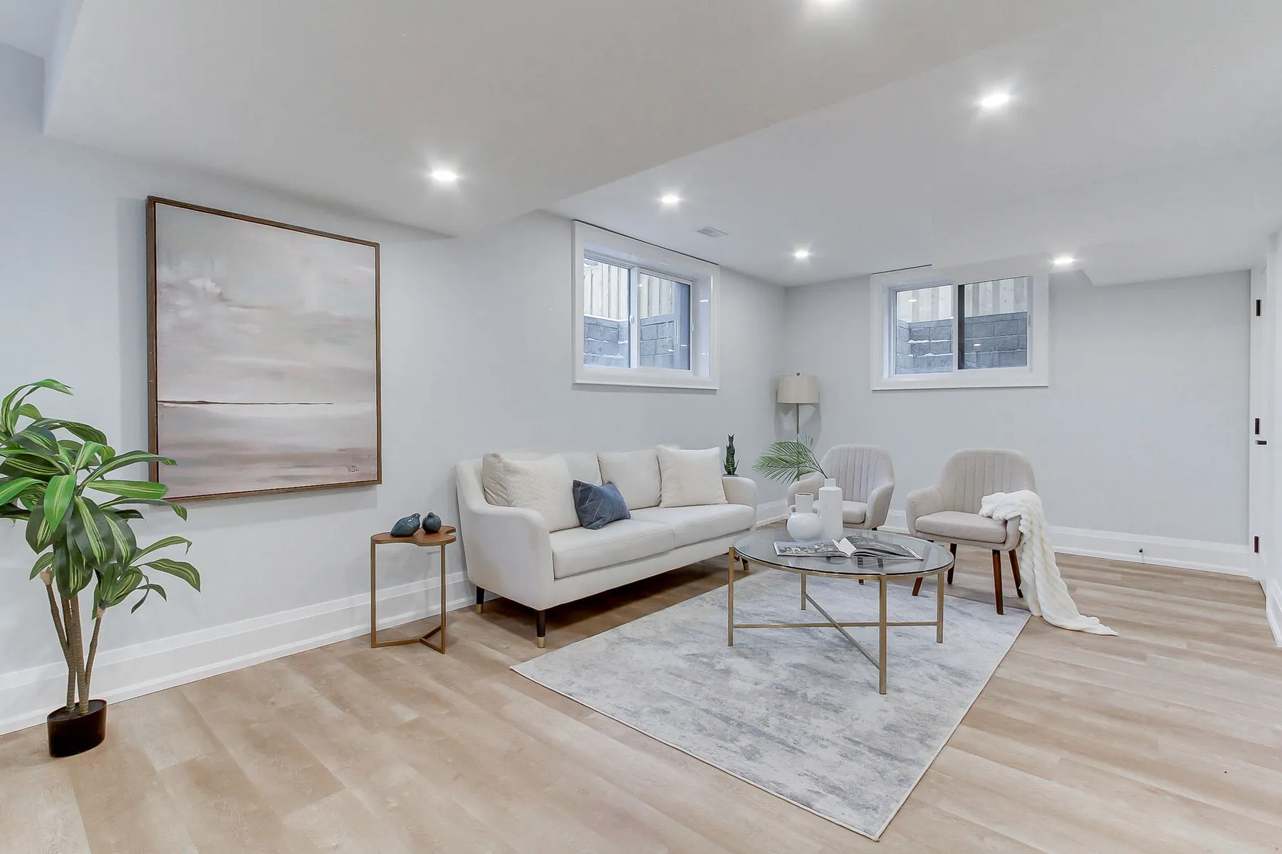 A finished basement rec room with built-in seating and shelving