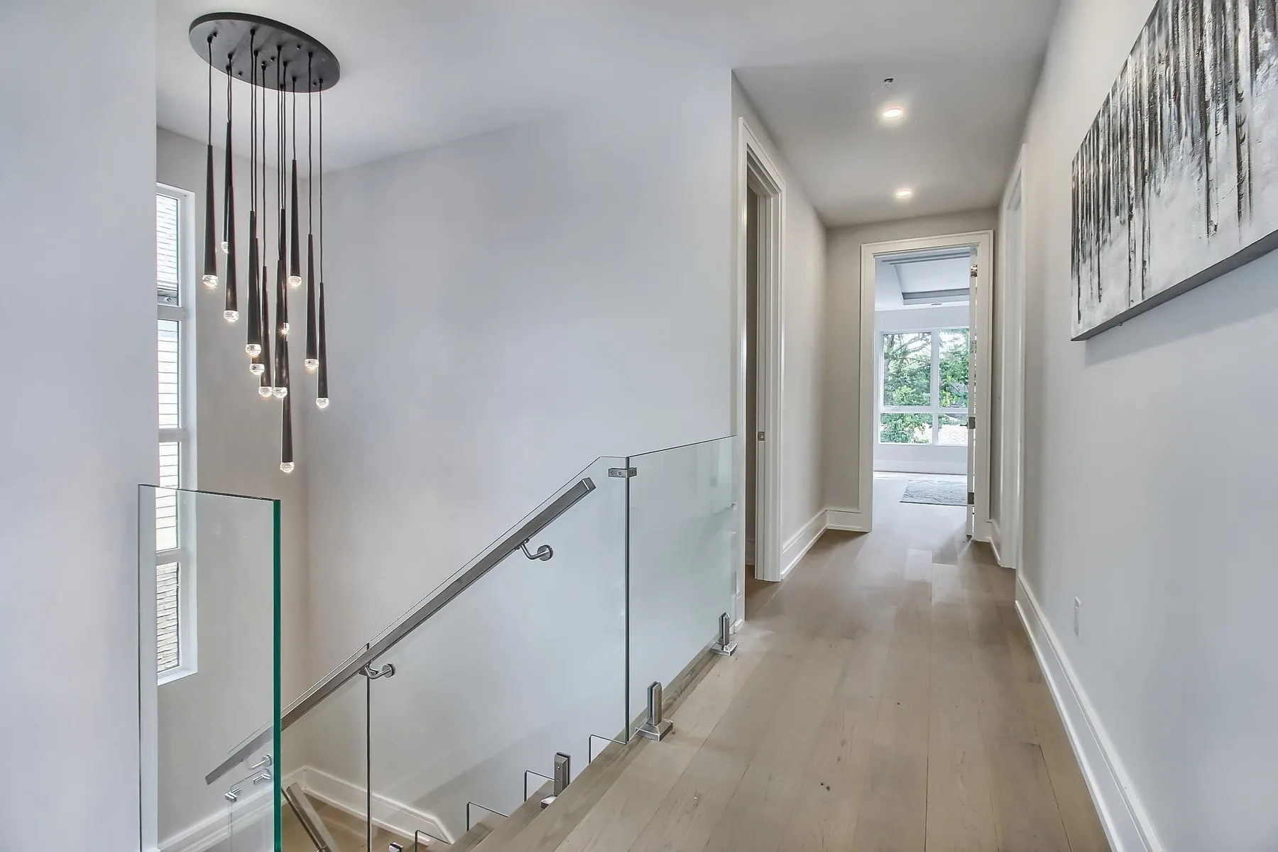Upper-floor hallway with oak flooring and panelled doors in an Oakville custom home